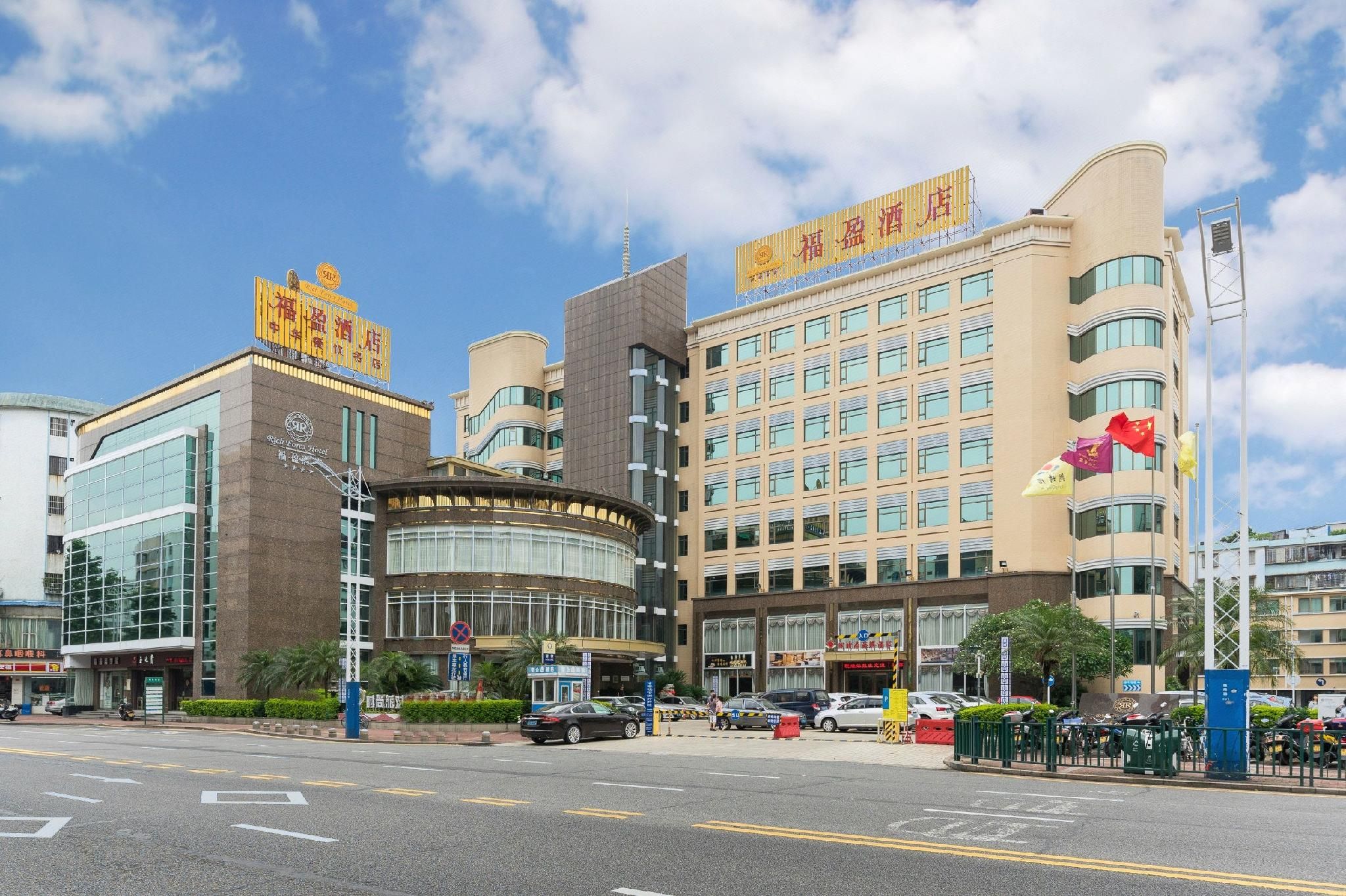 A hotel with a modern facade, multiple floors, and a prominent sign.