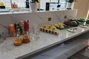 A breakfast buffet with various food items and beverages.