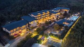 A multi-story building with a symmetrical layout, featuring a central courtyard and multiple entry points.