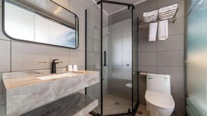 A modern bathroom with a glass-enclosed shower, a marble vanity, and a toilet. - Sangpin E-sports Hotel (Wenzhou Guoxi Branch) (Wenzhou)