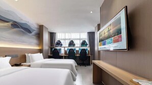 A hotel room with two beds, a desk with computers, and a large TV on the wall. - Sangpin E-sports Hotel (Wenzhou Guoxi Branch) (Wenzhou)