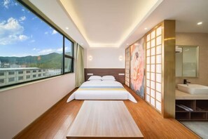 A modern hotel room with a large bed, a view of the city, a bathroom with a large mirror, and a wooden floor. - Shenzhen Haiya Boutique Hotel (Shenzhen)