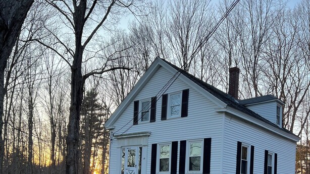 A two-story white house with black shutters, a chimney, and a front porch. - Home Away from Home- Discover Comfort and Convenience in this 4 Bedroom Home  (Holden)
