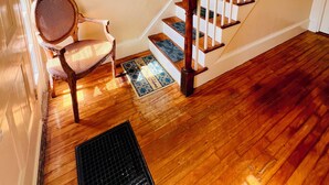 A wooden staircase with white railings and a handrail, leading to an upper floor. - Home Away from Home- Discover Comfort and Convenience in this 4 Bedroom Home  (Holden)