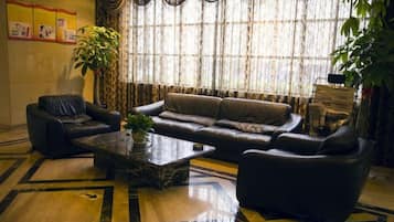A living room with a sofa, armchairs, and a coffee table.