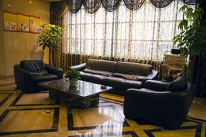 A living room with a sofa, armchairs, and a coffee table.
