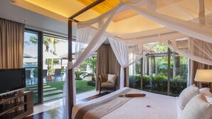 A bedroom with a canopy bed, a television, and a view of the outdoors. - Baan Leelawadee (Koh Samui)