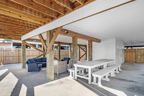 Relax in an outdoor space with a dining table and comfortable seating.