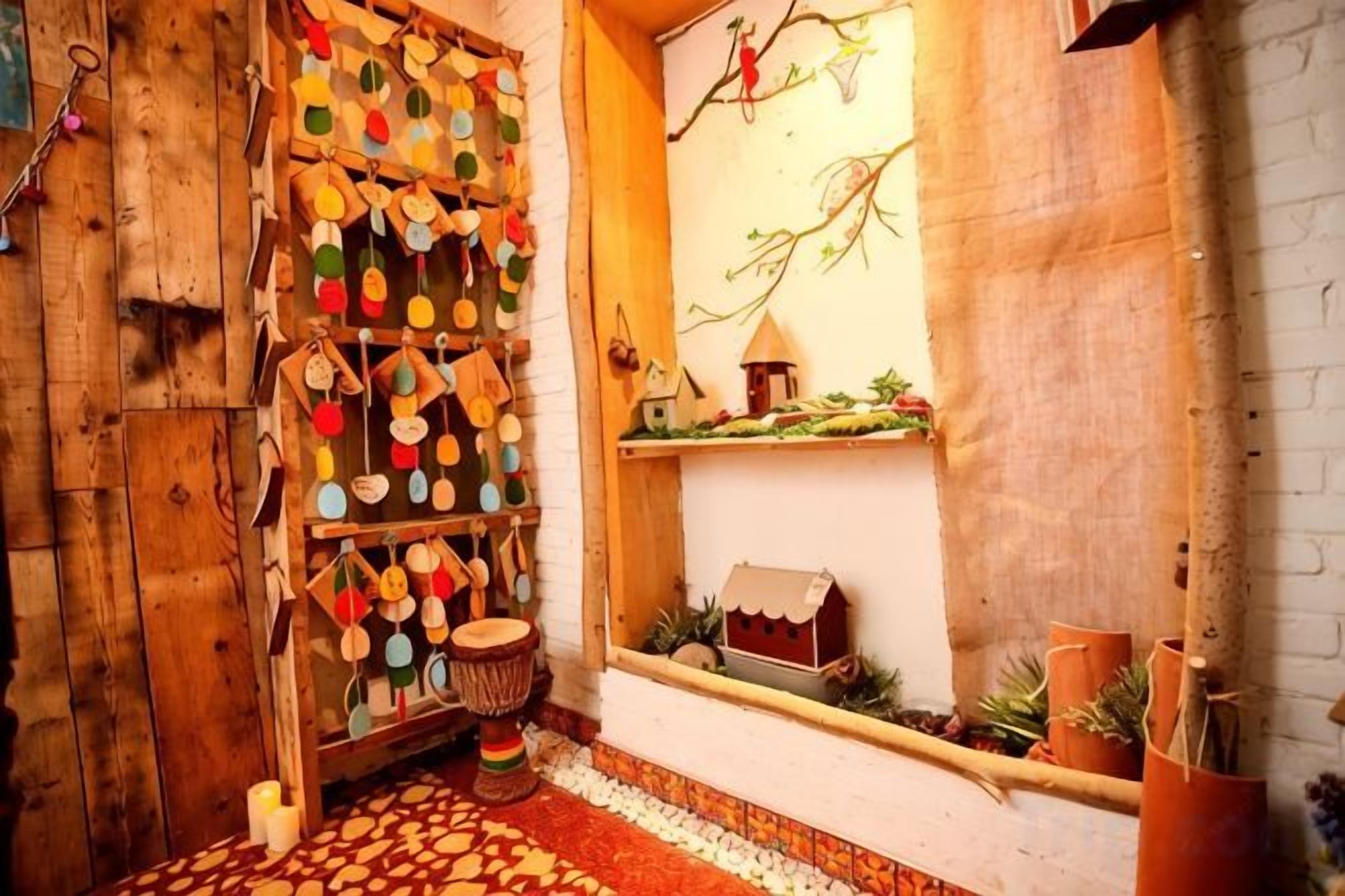 A rustic interior with a wooden wall, a shelf with decorative items, and a small house model.