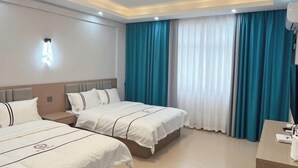 A hotel room with two beds, a desk, and a large window with curtains. - Beihai Wangzu Hotel (Beihai)