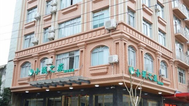 A multi-story hotel with a classic architectural style, featuring arched windows and a central entrance. - Xiaocheng Zhilv Hotel (Cenxi)