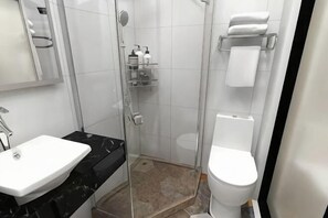 A bathroom with a white sink, a toilet, a glass shower enclosure, and a towel rack. - Xiaocheng Zhilv Hotel (Cenxi)