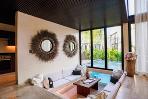 A modern living room with a sofa, coffee table, and decorative mirrors. - Trobbu Boutique Collection Riviera Maya - All Inclusive (Tulum)