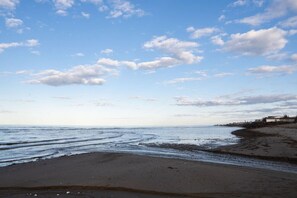 A beach with a clear sky and gentle waves. - Get-A-Way Beach Chalet (Grande-Digue)