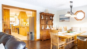 A dining area with a wooden table, chairs, and a decorative cabinet.