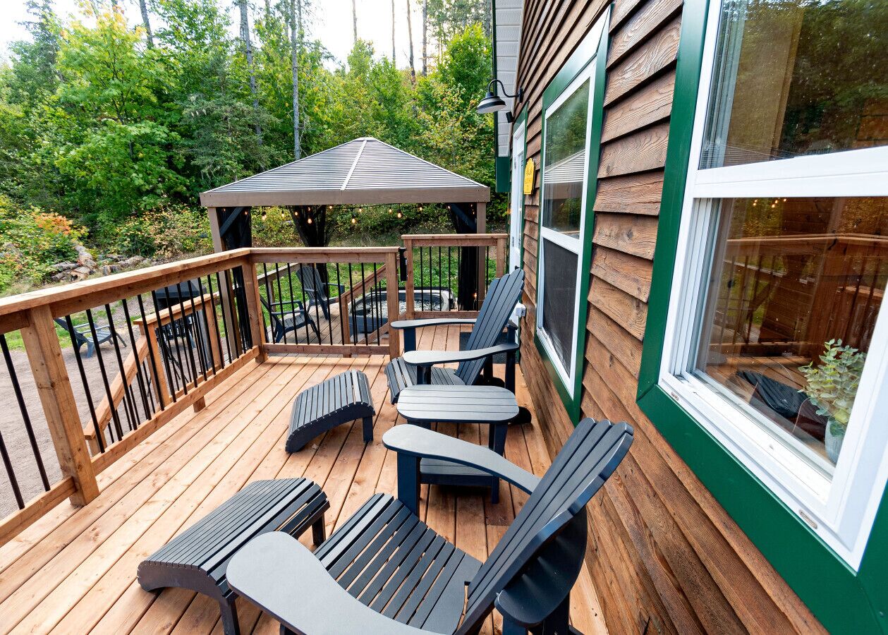 Una terrazza in legno con posti a sedere all'aperto e una zona coperta.