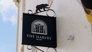 Un letrero que dice 'The Harvey' con una silueta de oso, fundado en 1797, colocado en un edificio.