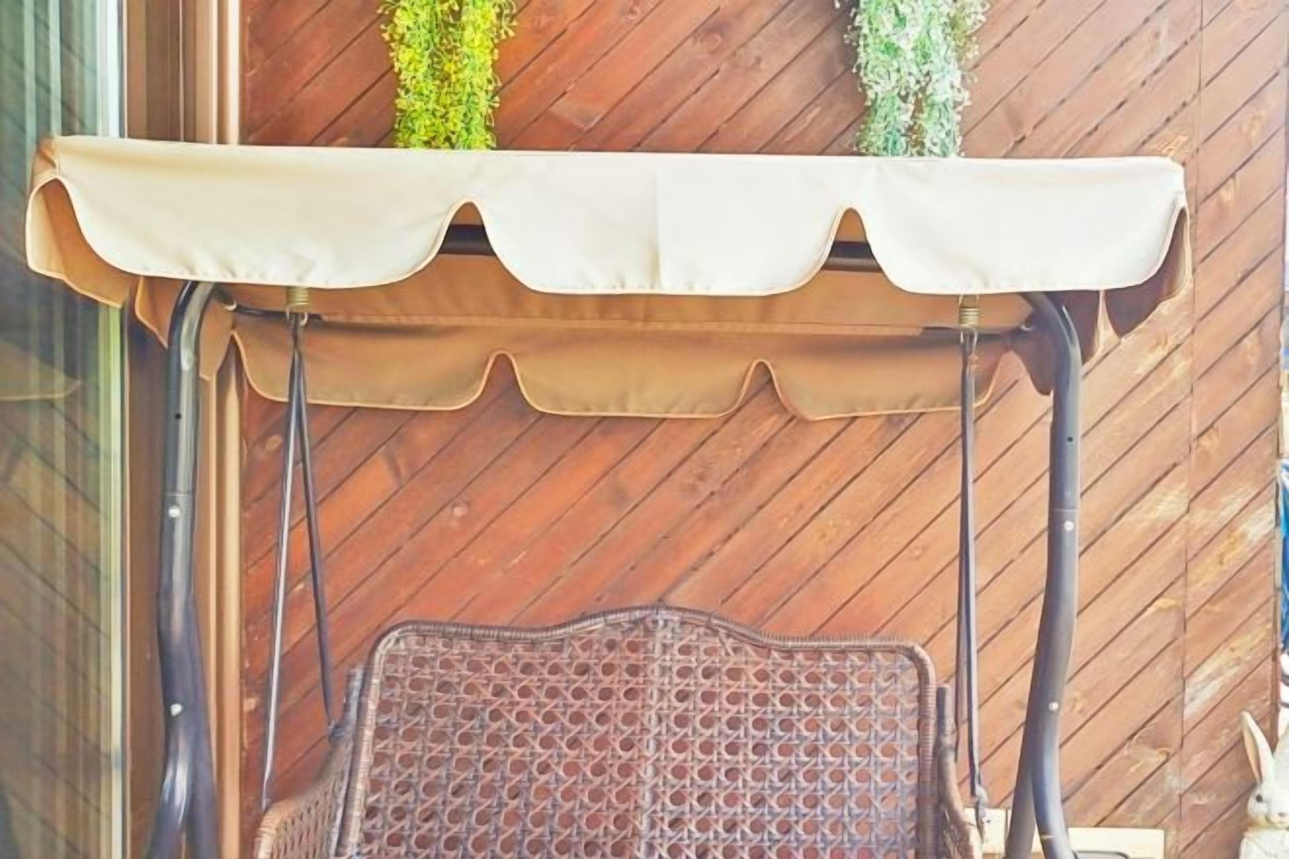 Un espacio de estar al aire libre cubierto con una silla de metal y una mesa.