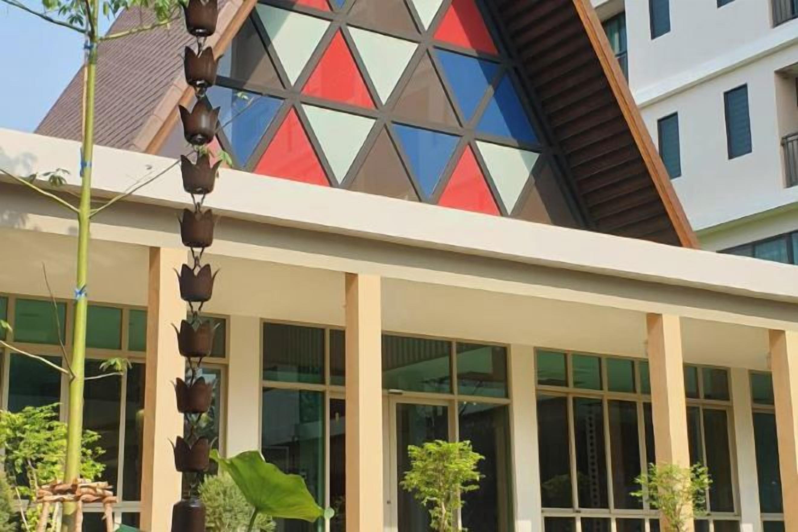 A building with a modern architectural design, featuring a geometric facade and large windows.