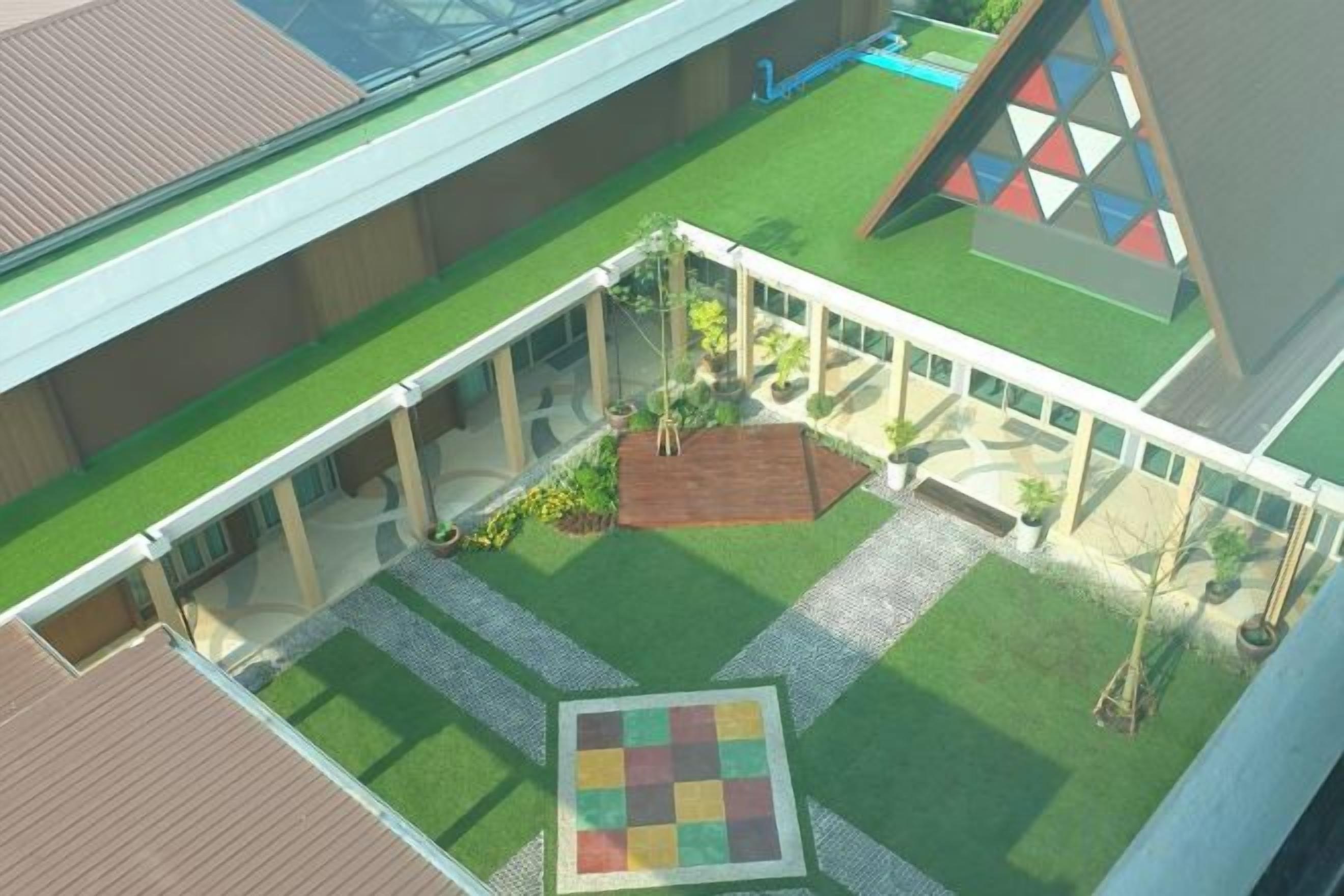 A courtyard with a central garden area, surrounded by buildings with a modern architectural style.