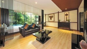 Una sala moderna con sofá, mesa de centro y vista a zonas verdes.