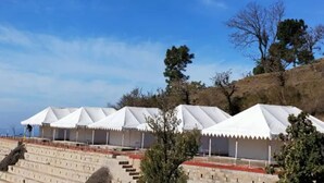 A row of white tents with a stone staircase leading up to them. - Hill Ventures (Dharamshala)