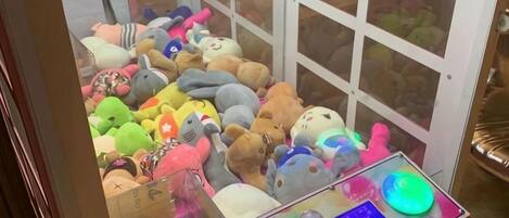 A claw machine filled with plush toys.