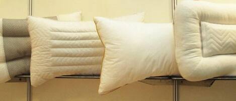 A bed with multiple pillows and a headboard.