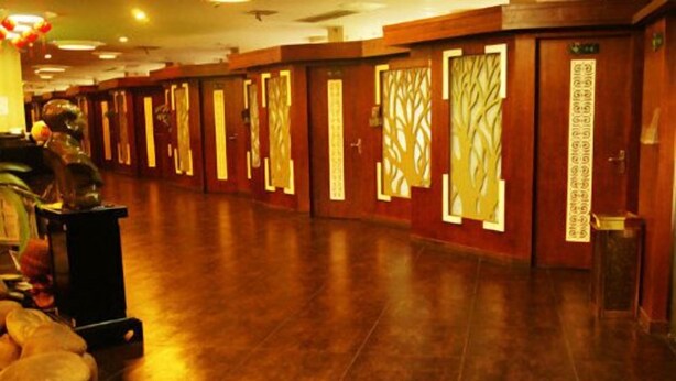 A hotel corridor with wooden doors and a polished floor. - Ming Dian Hotel (Shaoshan)
