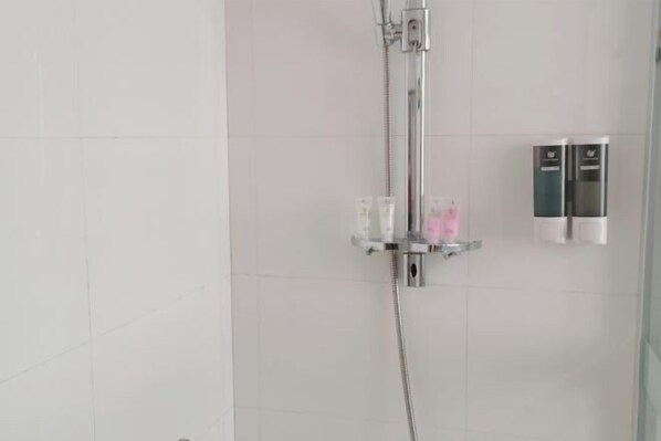A shower with a handheld showerhead, a glass shelf with toiletries, and a towel rack. - Sun Holiday Resort (Changxing)