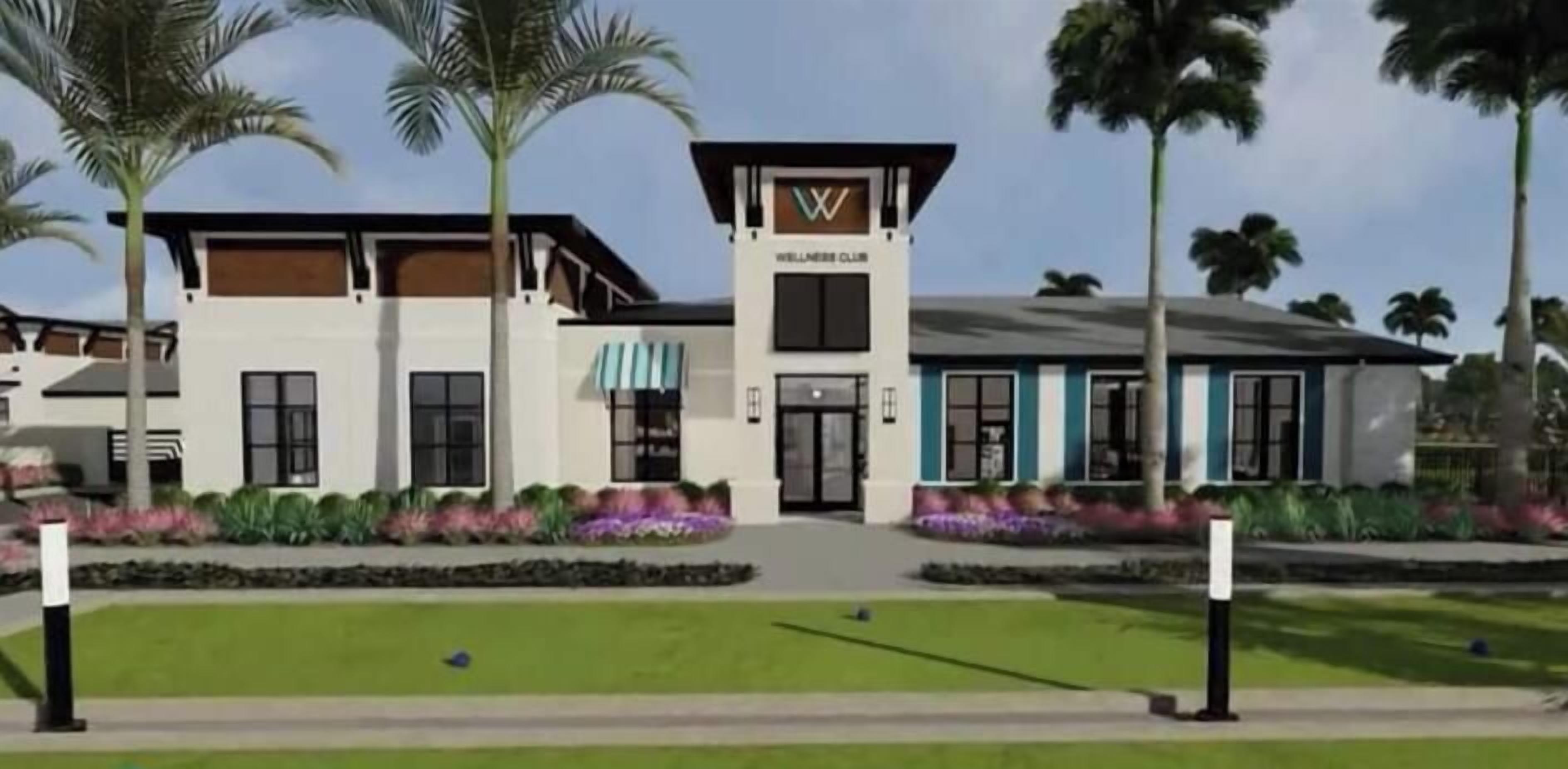 A modern wellness club building with a central entrance, surrounded by landscaped gardens and palm trees.
