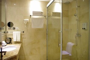 A modern bathroom with a glass-enclosed shower, a sink with a marble countertop, and a towel rack. - Sopley li zhi Hotel (Zhengzhou)
