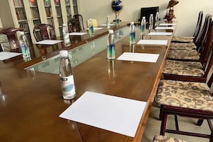 A conference room with a long table, chairs, and water bottles.