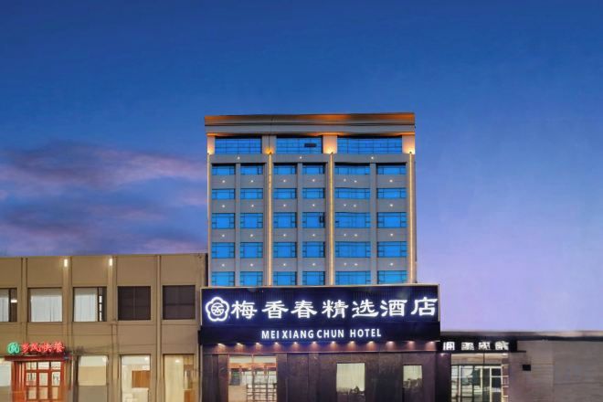 Un edificio de hotel con un letrero que indica que es el Hotel Meixiang Chun.