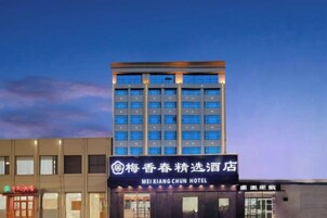 Un edificio de hotel con un letrero que indica que es el Hotel Meixiang Chun.