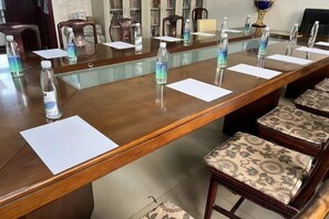A conference room with a long table, chairs, water bottles, and papers. - Meixiangchun Collection Hotel (Datong Yungang District) (Datong)