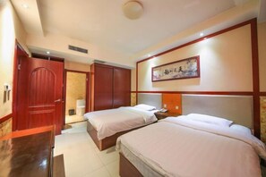 A hotel room with two single beds, a wooden wardrobe, a desk, and a bathroom with a toilet and sink. - Meixiangchun Collection Hotel (Datong Yungang District) (Datong)