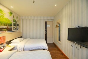 A hotel room with two beds, a TV, and a window with a view of palm trees. - Mango Hotel (Hanzhong Tiantai Road) (Hanzhong)
