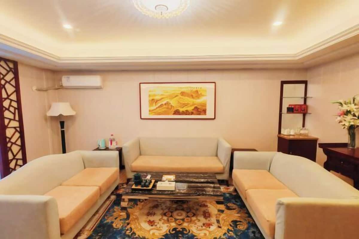 A room with two sofas, a coffee table, a framed picture, a lamp, and a mirror.