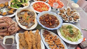 A table with various seafood dishes, including fried fish, shrimp, and oyster cakes. - Dongdaihe Haizhiyuan Guesthouse (Suizhong)
