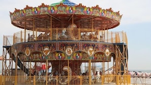A carousel with a colorful, ornate design and a central red top. - Dongdaihe Haizhiyuan Guesthouse (Suizhong)