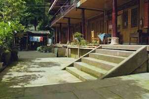 Un edificio tradicional con una escalera que lleva a un porche cubierto.