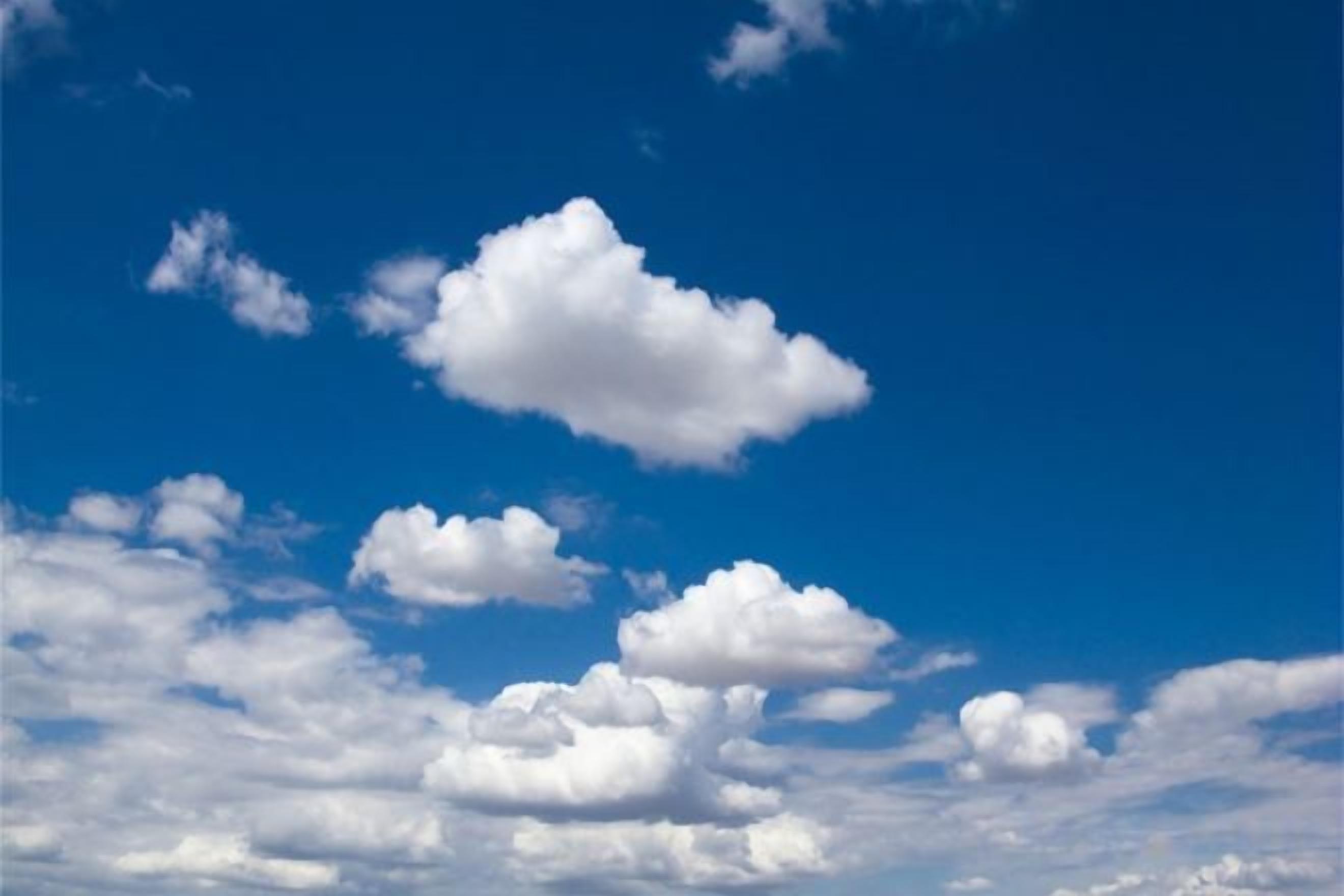 A clear sky with scattered clouds.