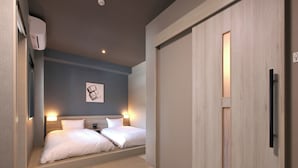 A hotel room with a bed, bedside tables, a wall-mounted air conditioner, a ceiling light, and a door with a handle. - Hotel Route Inn Grand Chichibu (Chichibu)