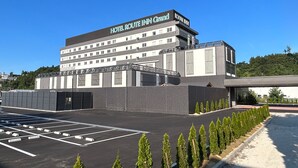 A multi-story hotel with a modern design, featuring a prominent sign reading "HOTEL ROUTE INN Grand." - Hotel Route Inn Grand Chichibu (Chichibu)