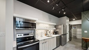 A modern kitchen with built-in appliances, a large oven, and a refrigerator.