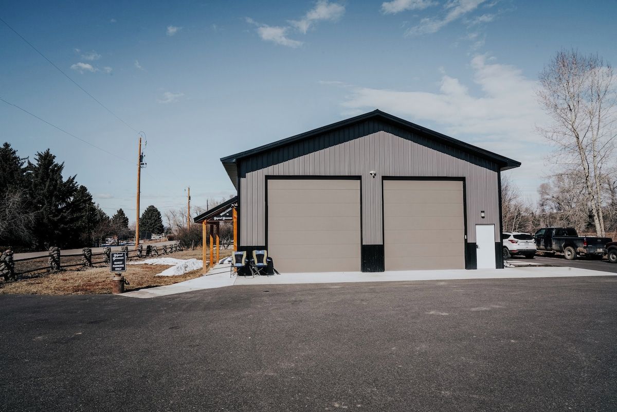 A two-story industrial building with a flat roof and large garage doors.
