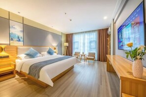 Relax in a spacious room with a large bed, seating area, and flat-screen TV.