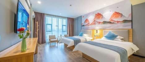 A hotel room with two beds, a desk, a chair, a TV, and a painting on the wall.