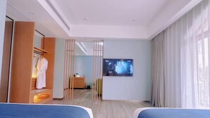A hotel room with two beds, a TV, a wardrobe, and a view of the city. - Venus Resort & Restaurant (Chongzuo)